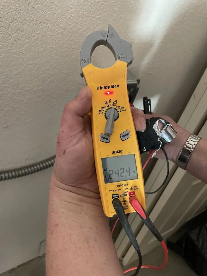 Voltage testing with clamp meter during Outlet Installation in Amenia
